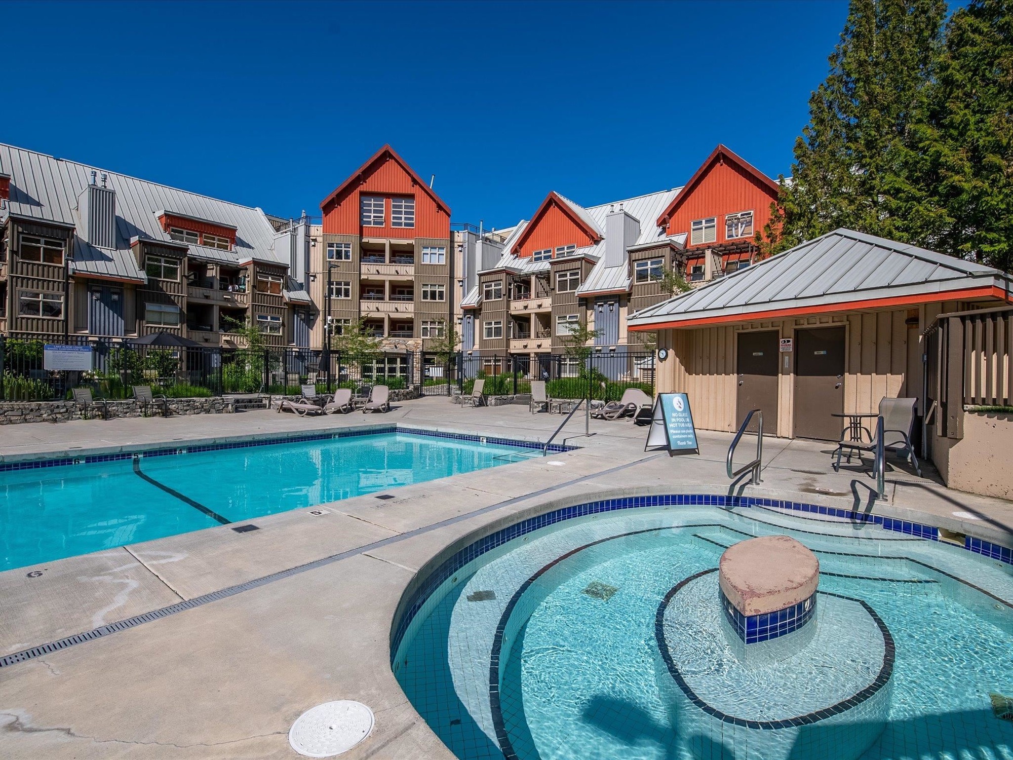Outdoor swimming pool and hot tub at a Whistler resort property
