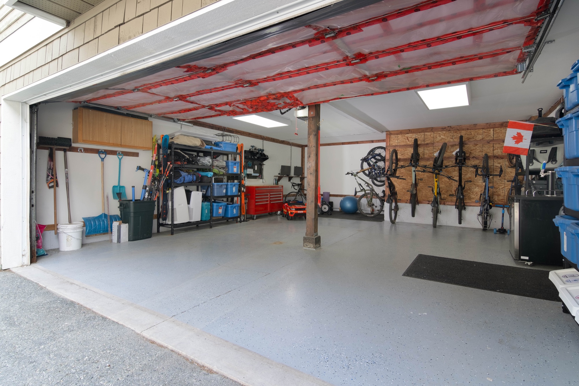 Organized Pemberton garage with bike, ski, vehicle, and equipment storage
