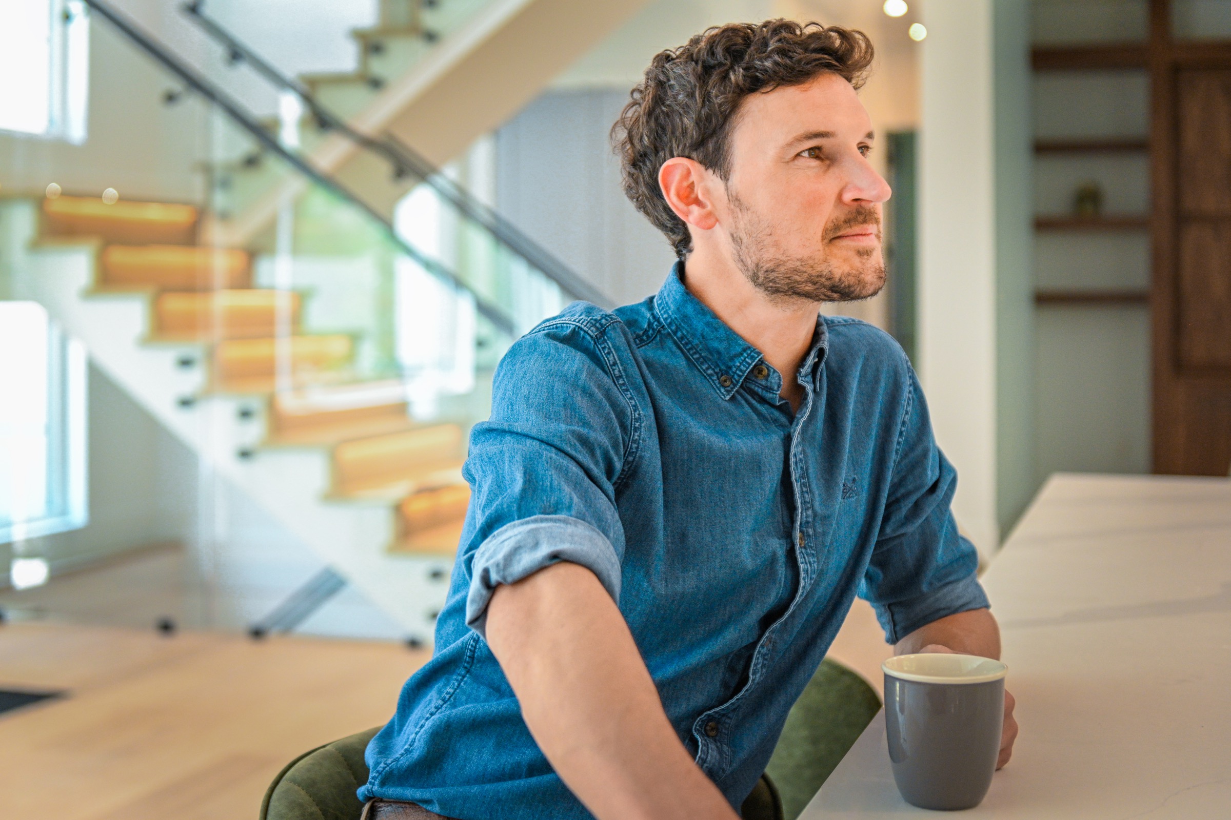 Richard Grenfell speaking with a client in a contemporary home