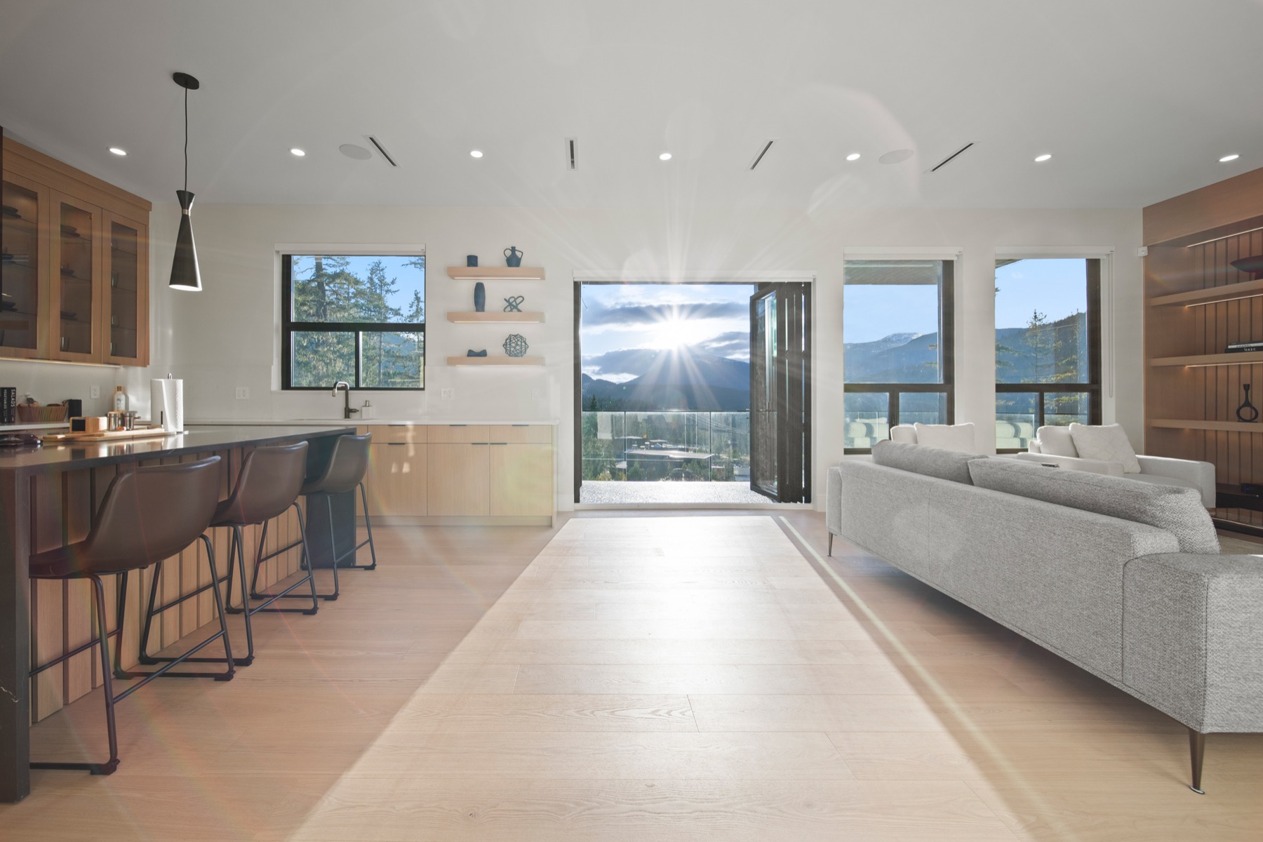 Sunlit contemporary great room with a mountain view at 9289 Stellar’s Way