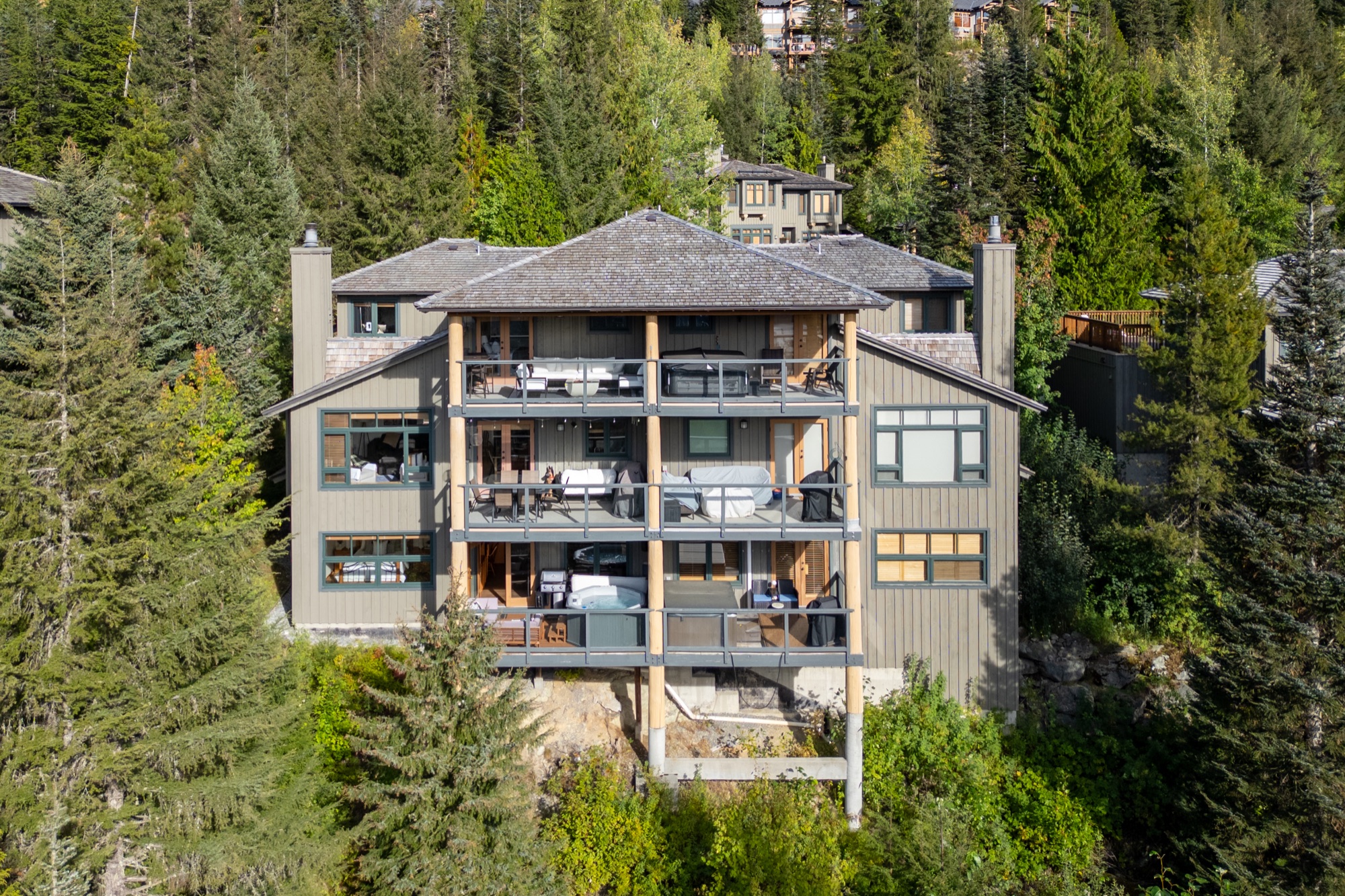 Whistler condominium building surrounded by forest near the mountain
